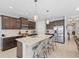 Stylish kitchen with granite countertops, stainless steel appliances, and an island with barstool seating at 220 Cassano Dr, Nokomis, FL 34275