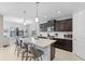 Modern kitchen with stainless steel appliances, granite countertops, and an island with bar seating at 220 Cassano Dr, Nokomis, FL 34275