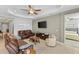 Inviting living room with leather sofas, tray ceiling, and neutral colors at 220 Cassano Dr, Nokomis, FL 34275
