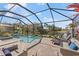 Enjoy Florida outdoor living with a covered pool, spa, and beautiful lake views at 220 Cassano Dr, Nokomis, FL 34275