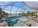 A screened in pool and jacuzzi with an amazing view of the lake at 220 Cassano Dr, Nokomis, FL 34275