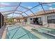 The outdoor living space features a pool and jacuzzi with ample patio seating at 220 Cassano Dr, Nokomis, FL 34275