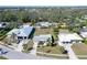 Aerial view of the property showcasing its location amongst other homes and mature trees at 2406 Breakwater Cir, Sarasota, FL 34231