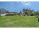 Picturesque backyard with lush green grass and mature trees at 2406 Breakwater Cir, Sarasota, FL 34231