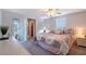 Bedroom featuring a ceiling fan, natural light, and adjacent sliding doors leading to the lanai at 2406 Breakwater Cir, Sarasota, FL 34231