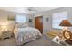 Comfortable bedroom featuring neutral walls, natural light, and beach-inspired decor at 2406 Breakwater Cir, Sarasota, FL 34231