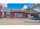 Casual cafe featuring a vibrant exterior with colorful signage, a tiki hut and outdoor seating at 2406 Breakwater Cir, Sarasota, FL 34231