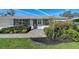 Charming single-story home featuring well-manicured landscaping and a welcoming front entrance at 2406 Breakwater Cir, Sarasota, FL 34231