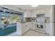 Well-lit kitchen equipped with modern appliances and opens to a lovely screened-in porch at 2406 Breakwater Cir, Sarasota, FL 34231