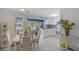 Inviting kitchen featuring white cabinetry, a view of a screened lanai, and adjacent dining area at 2406 Breakwater Cir, Sarasota, FL 34231