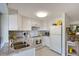 Bright kitchen featuring white cabinets, stainless steel appliances, and stylish tile backsplash at 2406 Breakwater Cir, Sarasota, FL 34231