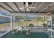 Well-lit screened-in lanai with multiple seating areas and great backyard view at 2406 Breakwater Cir, Sarasota, FL 34231
