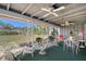 Spacious screened-in lanai boasting dining and seating areas plus great backyard view at 2406 Breakwater Cir, Sarasota, FL 34231