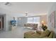 Bright living room with tile flooring, a ceiling fan, and cozy furniture at 2406 Breakwater Cir, Sarasota, FL 34231