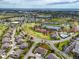 Aerial view of a residential community with single Gathering homes near a golf course and lake at 2904 Captains Ct # 2904, Palmetto, FL 34221