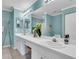 Bright bathroom features double sinks, vanity and mirrors and tiled floors at 2904 Captains Ct # 2904, Palmetto, FL 34221