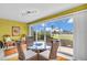 The dining room features a glass table, wicker chairs, and sliding glass doors to the outdoor area at 2904 Captains Ct # 2904, Palmetto, FL 34221