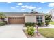 Charming single-story home featuring an attached garage, a well-manicured lawn, and neutral stucco at 2904 Captains Ct # 2904, Palmetto, FL 34221