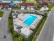 Aerial view of a community pool, surrounded by lush landscaping, lounge chairs, and cabanas at 2904 Captains Ct # 2904, Palmetto, FL 34221