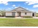 Well maintained rear exterior shows backyard with manicured green grass, exterior doors and windows at 2904 Captains Ct # 2904, Palmetto, FL 34221