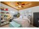 Bedroom with wood ceiling, fan, light colored carpet, a bed, and storage at 2918 8Th W Ave, Bradenton, FL 34205