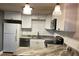 Well-lit kitchen featuring white cabinetry, granite countertops, stainless steel appliances and modern fixtures at 3008 Hillview St, Sarasota, FL 34239