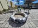 Relaxing backyard with a stone firepit surrounded by patio pavers and comfortable seating at 3507 65Th Avenue E Cir, Sarasota, FL 34243