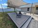 Inviting backyard deck with shade sail offers a perfect spot for outdoor relaxation at 3507 65Th Avenue E Cir, Sarasota, FL 34243