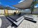 Spacious backyard deck with shade sail, ideal for outdoor lounging and entertaining at 3507 65Th Avenue E Cir, Sarasota, FL 34243