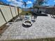 Beautiful backyard featuring a brick-paved area with fire pit, chairs and shade structure for outdoor enjoyment at 3507 65Th Avenue E Cir, Sarasota, FL 34243