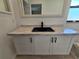 Close-up of a bathroom vanity with marble-look countertop, dark hardware, and a rectangular undermount sink at 3507 65Th Avenue E Cir, Sarasota, FL 34243