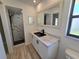 Modern bathroom with a spacious walk-in shower, black fixtures and a sleek vanity for contemporary elegance at 3507 65Th Avenue E Cir, Sarasota, FL 34243