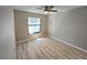 Bright bedroom with light walls, modern ceiling fan, and laminate flooring at 3507 65Th Avenue E Cir, Sarasota, FL 34243