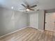Bright bedroom featuring neutral walls, ceiling fan, new vinyl floors, and a double-door closet at 3507 65Th Avenue E Cir, Sarasota, FL 34243