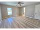 Spacious bedroom with hardwood floors, a ceiling fan, and natural light at 3507 65Th Avenue E Cir, Sarasota, FL 34243