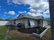 A single Gathering home with tidy landscaping and a white privacy fence, providing both beauty and security at 3507 65Th Avenue E Cir, Sarasota, FL 34243