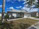 Beautifully landscaped single-story home with a two-car garage and shuttered windows at 3507 65Th Avenue E Cir, Sarasota, FL 34243
