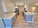 Charming kitchen with white and gray cabinets, stainless appliances, and a stylish breakfast bar at 3507 65Th Avenue E Cir, Sarasota, FL 34243