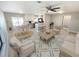 Open-concept living space with a blend of living and dining areas, and a view of the kitchen with modern appliances at 3507 65Th Avenue E Cir, Sarasota, FL 34243