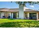 Spacious backyard with lush lawn, patio seating, and well-maintained landscaping at 3641 Gleneagle Dr # 12D, Sarasota, FL 34238
