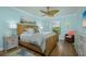 Stylishly decorated bedroom with wicker bedframe, coastal-themed decor, and hardwood floors at 3641 Gleneagle Dr # 12D, Sarasota, FL 34238