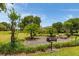 Community barbecue area with grill, picnic table and landscaped surroundings, ideal for gatherings at 3641 Gleneagle Dr # 12D, Sarasota, FL 34238