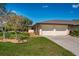 Charming home with a two-car garage, lush lawn, and meticulously arranged landscaping at 3641 Gleneagle Dr # 12D, Sarasota, FL 34238