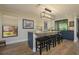 Kitchen island featuring stone countertops, dark blue cabinets, stylish pendant lighting, and bar stool seating at 3641 Gleneagle Dr # 12D, Sarasota, FL 34238