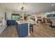 Spacious kitchen island with stone countertops, dark blue cabinets, and a view of the living and dining areas at 3641 Gleneagle Dr # 12D, Sarasota, FL 34238