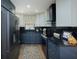 Modern kitchen featuring two tone cabinets, dark countertops, stainless steel appliances, and decorative accents at 3641 Gleneagle Dr # 12D, Sarasota, FL 34238