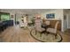 Open-concept living room with hardwood floors, modern furnishings, and a cozy dining area at 3641 Gleneagle Dr # 12D, Sarasota, FL 34238