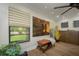 Relaxing living room featuring neutral colors, hard wood floors, stylish bench, and windows with peaceful outdoor views at 3641 Gleneagle Dr # 12D, Sarasota, FL 34238