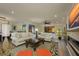Spacious living room with hardwood floors, stylish sofas, and an open layout connecting to the dining area at 3641 Gleneagle Dr # 12D, Sarasota, FL 34238