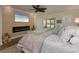 Comfortable main bedroom with a plush bed, area rug, fireplace, and outdoor views at 3641 Gleneagle Dr # 12D, Sarasota, FL 34238